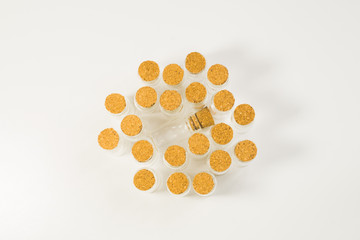 Empty little bottles with cork stopper on white backgtound. glass vessels. transparent containers. test tubes