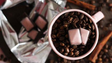 Pieces of dark chokolate and coffee beans, top view.
