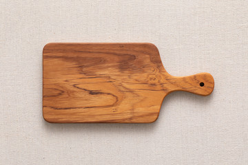 Handmade teak wood chopping board on burlap