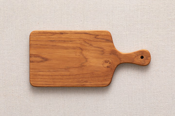 Handmade teak wood chopping board on burlap