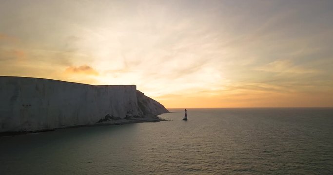 Aerial view of Beachy Head Lighthouse and white cliffs at sunrise Eastbourne , United Kingdom