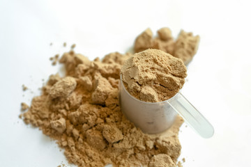 Scoop of whey protein with isolated white background.