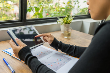 Close up of woman hands using tablet indoor