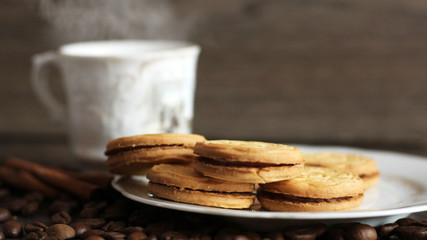 Round cookies with filling and a Cup of coffee