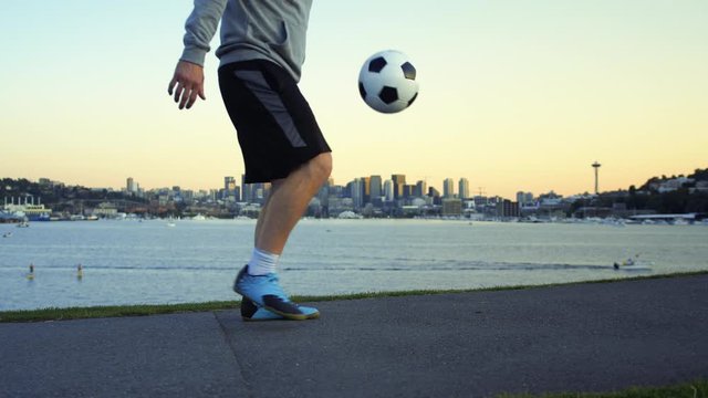 Slow Motion Soccer Ball Juggle with Seattle Waterfront Skyline Background