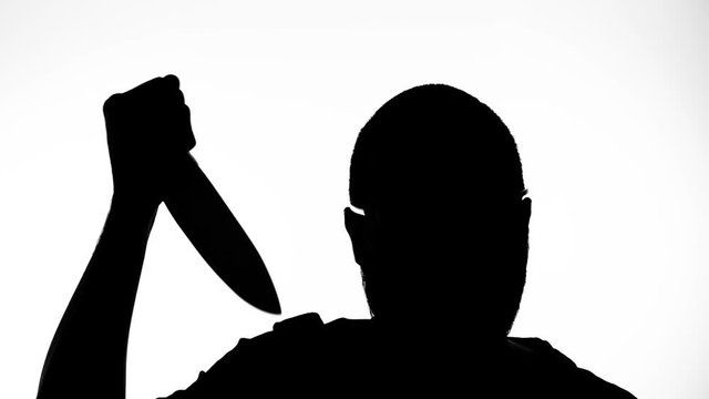 Silhouette of a dangerous killer with a knife