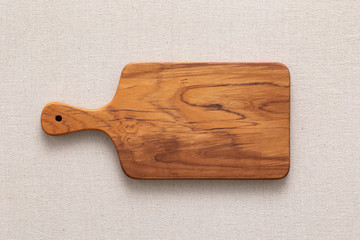 Handmade teak wood chopping board on burlap