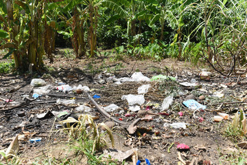 Garbage in the park spilled garbage on ground of the big city used dirty plastic bottles dirty...