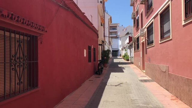 Passing by a Spanish Street in Fuengirola on a lazy summer's day as a solitary cat sits watching.