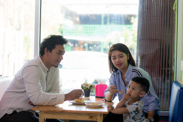 family enjoying the day at cafe in the morning