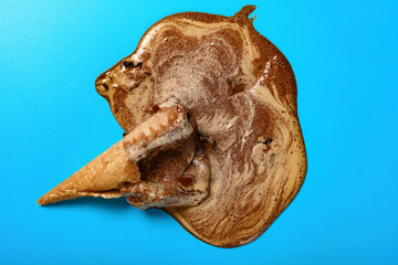 top view coffee flavor ice cream cone melted on a blue background