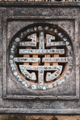 symbol on a lilac wall in the Royal Palace in the ancient imperial city of Hue, Vietnam