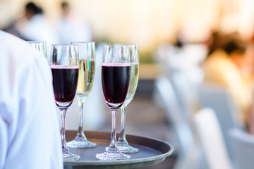 Restaurant staff Holding a glass of wine ready to serve at a party