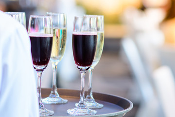 Restaurant staff Holding a glass of wine ready to serve at a party