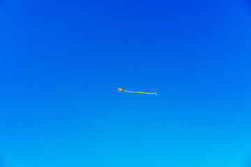 Kite centered in front of a bright blue sky