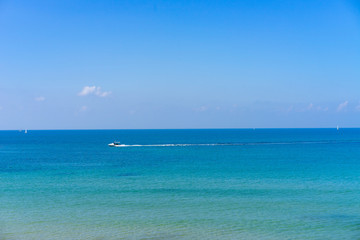 Boat going across a blue ocean