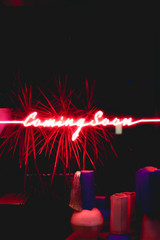 Neon sign that reads coming soon