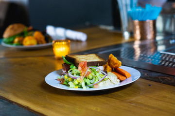 A healthy plate of food for lunch with salad, bread and veggies
