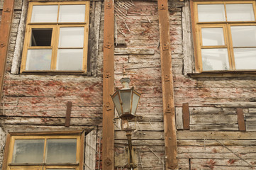 Windows of the old wooden house. wooden wall with windows and vintage lamp