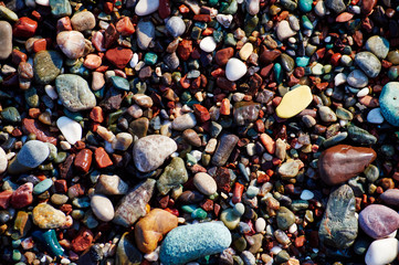 many wet multicolored pebbels on the sea beach