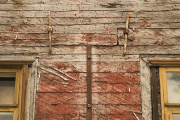 Windows of the old wooden house. wooden wall with windows