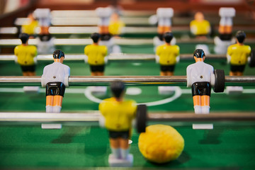 Table football, table football with close-ups of yellow and white players.