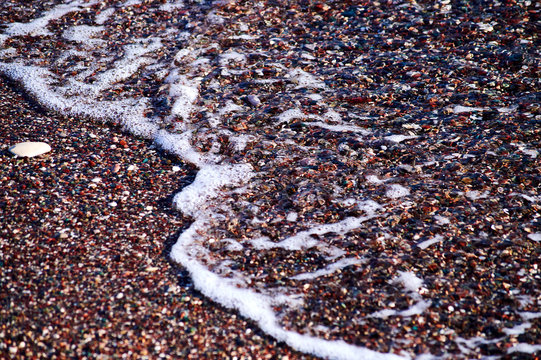 small slow sea wave cover sand and small pebbels on the beach in the lagoon