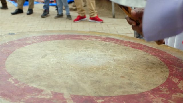 A man playing nagada and cymbal to entertain the crowd in a India's village fair. 