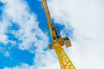 yellow crane against blue sky