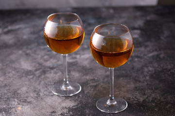 Two glasses with white wine on a textural background. Copy space. Place for your text.