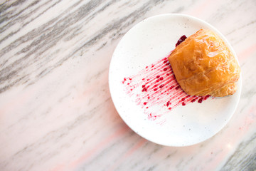 Strawberry jam on bread Croissant in the dish ready to serve