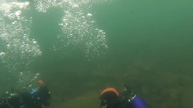 first dive in cold water, diving instructor conducting a shallow water scuba diving course in a Mountain Lake