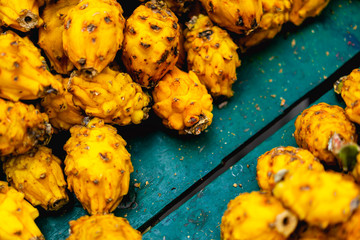 Yellow dragon fruit close up in a wooden cart