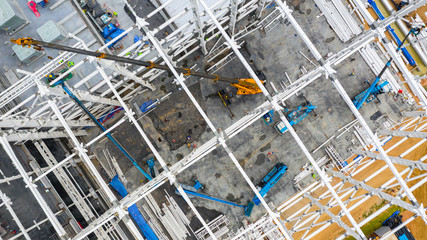 Aerial top view construction site with industrial machinery building for new  factory buildings.