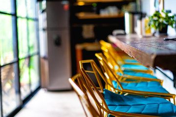 kitchen at an office with yellow chairs and a wooden bar area