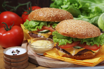 Two fresh hamburgers with vegetables