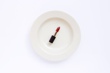 Lipstick on white dish  on white background.