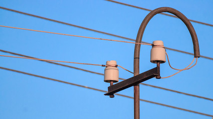 old electric pillar with glass insulators and wires