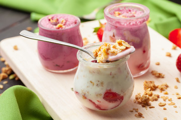 Healthy summer breakfast. Jar with granola, yoghurt and strawberry
