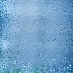 Drops of rain on the window glass. Shallow DOF. Window after rain. Blue Water background with water drops.