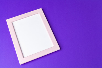 Blank photo frame with copy space on purple background
