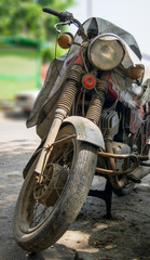 Dirty black bike with red details and dusty wheel parked on street