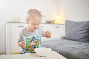 Kid eating icecream in the living room.