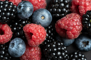 Macro view of mix with ripe blueberry, blackberry and raspberry fruits