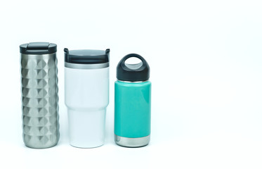 Isolated of three types of eco friendly and zero waste sport thermos stainless steel water bottles in teal white and silver color with black caps on white background with copy space on the right