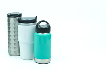 Isolated of three types of eco friendly and zero waste sport thermos stainless steel water bottles in teal white and silver color with black caps on white background with copy space on the right