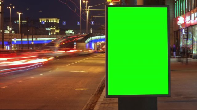 Modern billboard with a green screen on a busy highway with traffic, neon lights, timelapse of traffic at night, Moscow, Russia