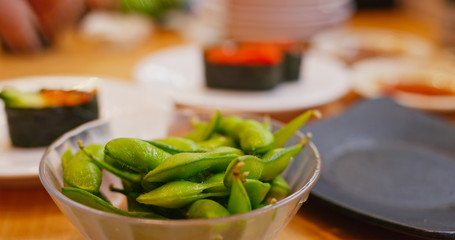 Eat edamame in Japanese restaurant