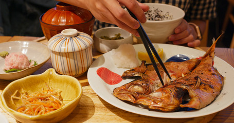 Set of the Japanese meal with bowl of rice and grilled fish