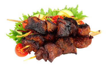 Barbecued burnt ends beef kebabs on wooden skewers with fresh salad isolated on a white background